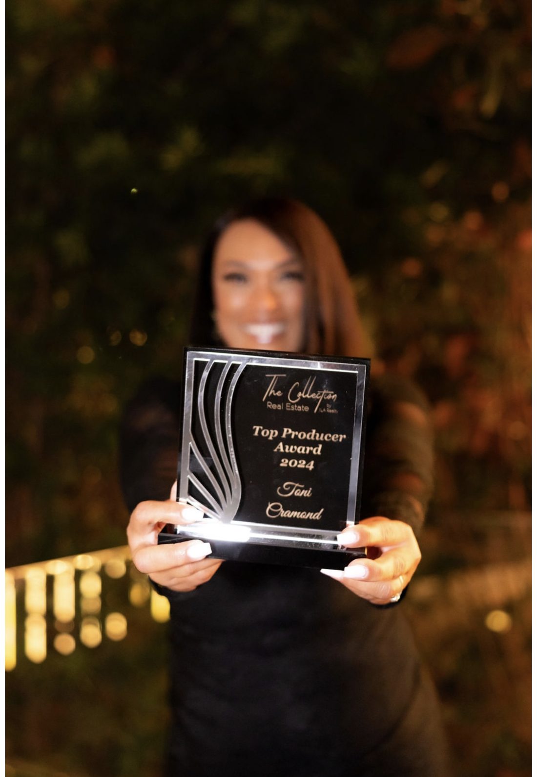 Toni Cramond holding her 2024 Top Producer Award