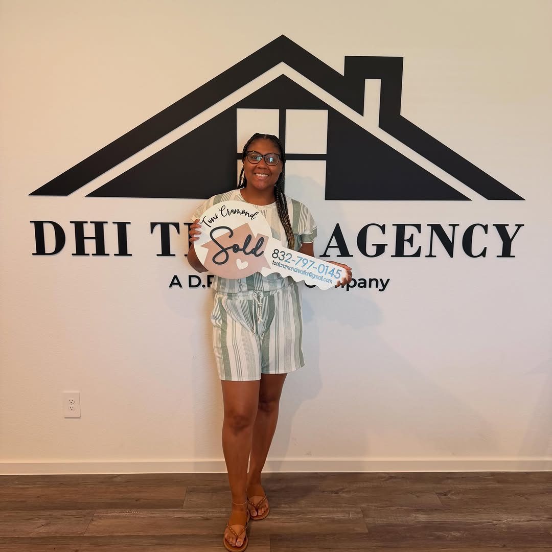 Closing day: a client holding her SOLD sign